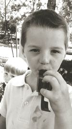 Close-up portrait of boy holding girl