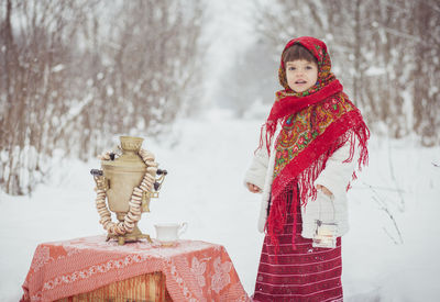 Girl in ancient ukrainian clothes in the winter in the forest