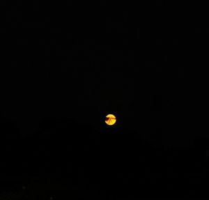 Low angle view of moon against sky at night