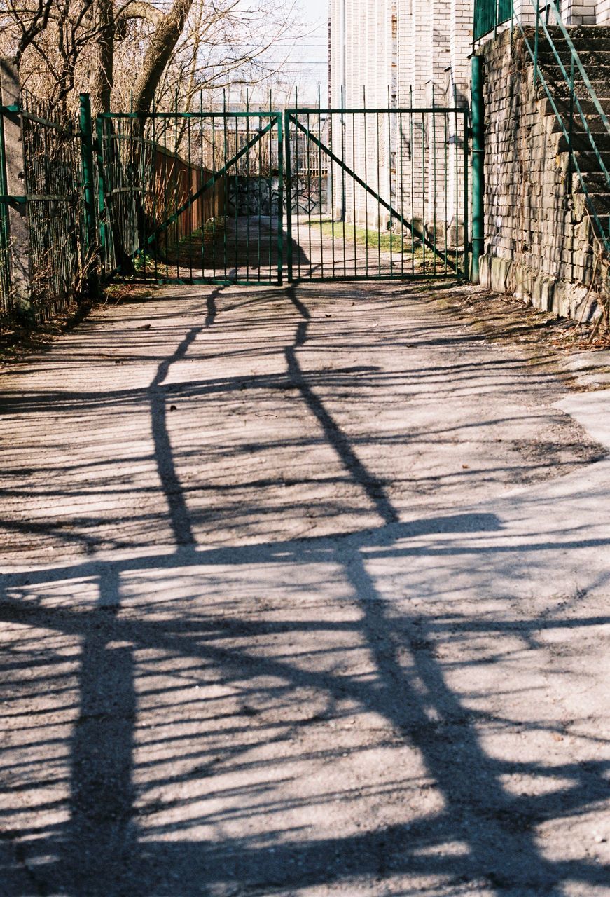 shadow, sunlight, built structure, day, outdoors, no people, tree, architecture, city, prison