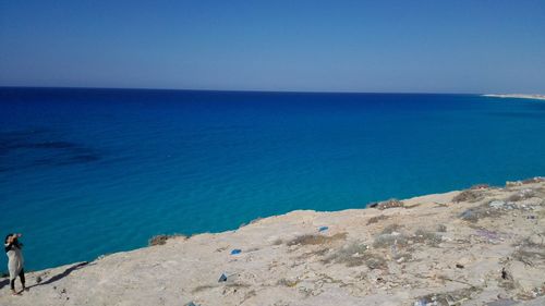 Scenic view of sea against clear blue sky