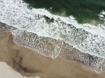 High angle view of surf on beach