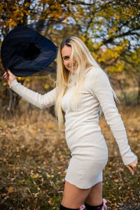 Portrait of young woman standing in park