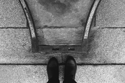 Low section of man standing on metal