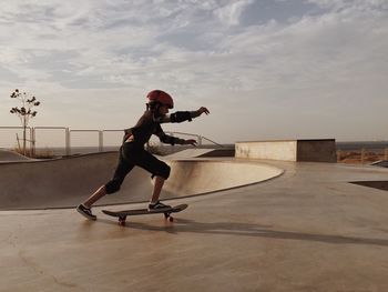 Full length of man skateboarding on skateboard in city