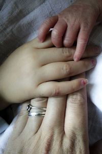 Cropped hands of mother and children