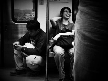 Rear view of people sitting on train