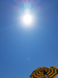 Low angle view of bright sun