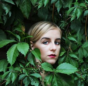 Portrait of a beautiful young woman with leaves