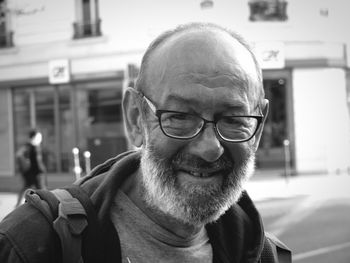 Close-up portrait of smiling man wearing eyeglasses