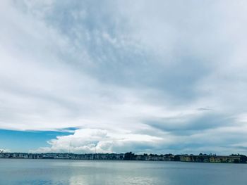 Scenic view of sea by buildings against sky