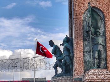 Low angle view of statue against sky