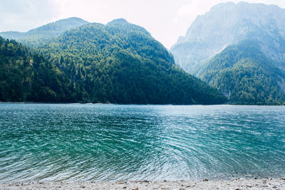 Scenic view of sea and mountains against sky