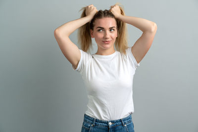 Portrait of a beautiful young woman against white background