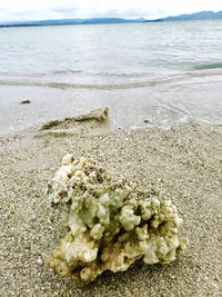 Close-up of sand on beach against sky