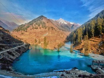 Scenic view of lake and mountains against sky