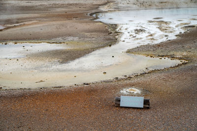 High angle view of wet shore at beach