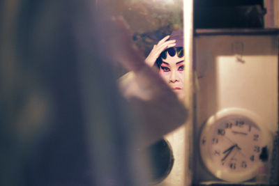 Cropped image of woman holding clock