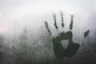 Close-up of raindrops on glass window