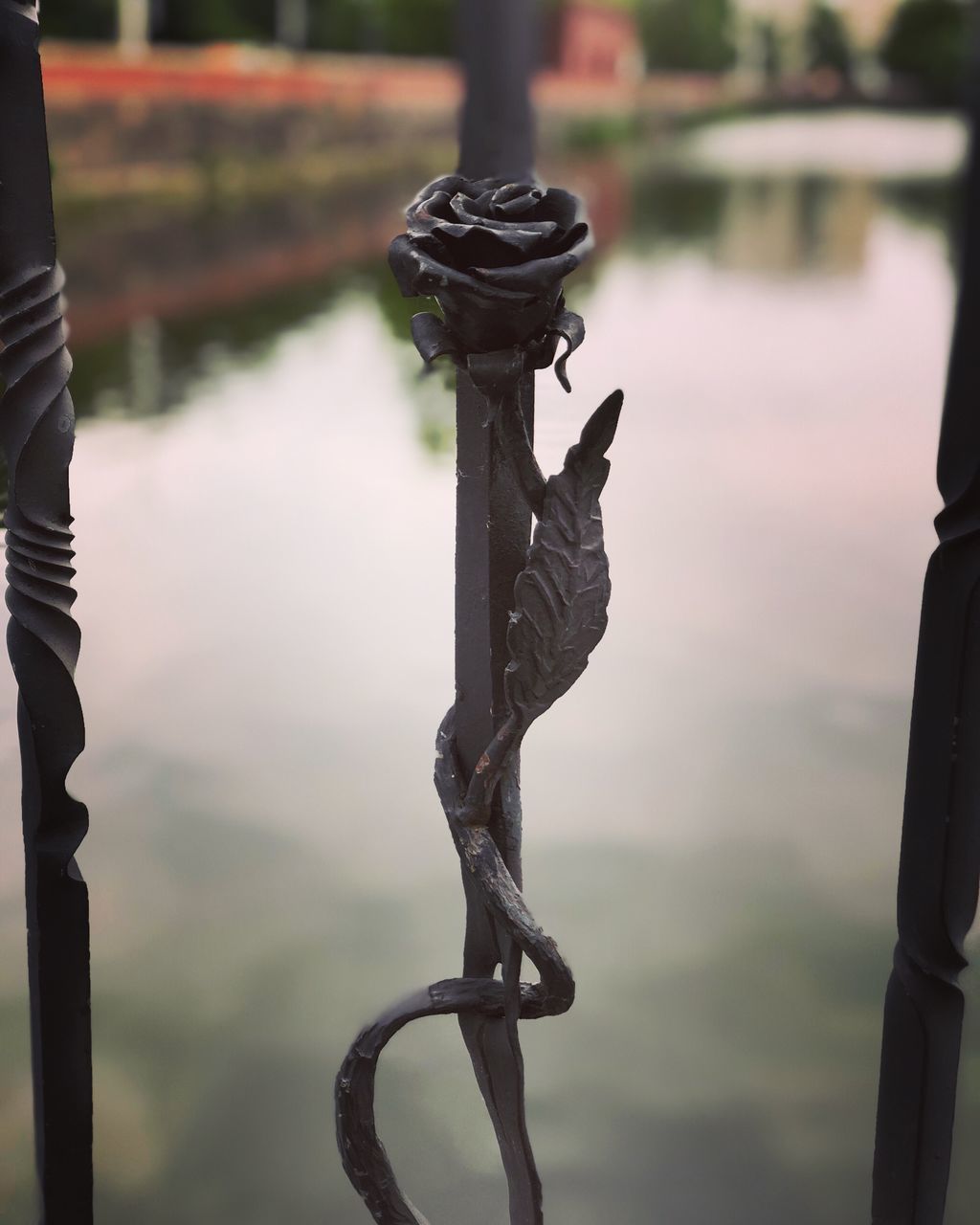 focus on foreground, no people, metal, water, day, close-up, nature, outdoors, security, lake, safety, protection, art and craft, sculpture, pattern, representation, tranquility, creativity, chain