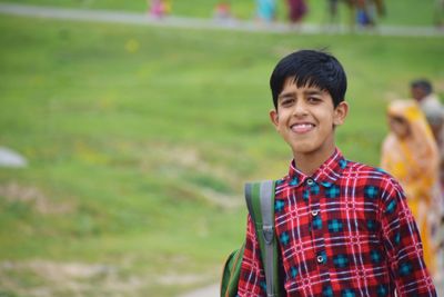 Portrait of smiling boy standing outdoors