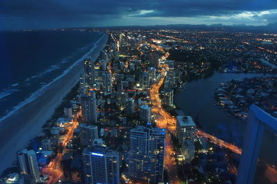 High angle view of city lit up at night