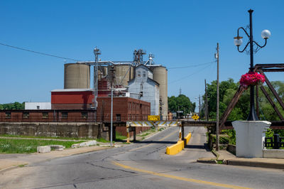 Street amidst buildings against clear sky