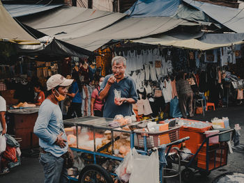 Panoramic view of people at market stall in city
