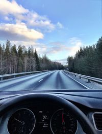 Close-up of cars on road against sky