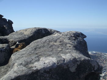 Scenic view of rocky mountains against blue sky