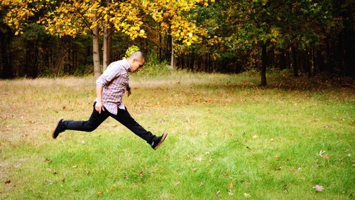 Full length of woman walking on grassy field