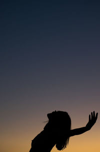 Portrait of silhouette woman against sky at sunset