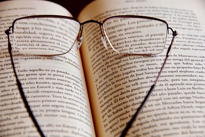 High angle view of eyeglasses on book