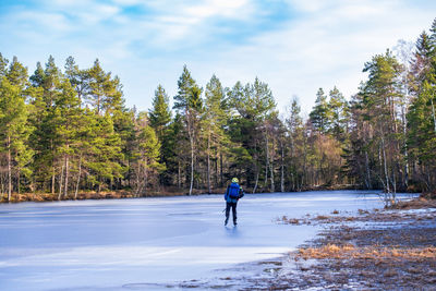 Tour skating on a frozen forest lake
