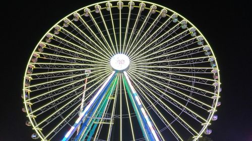 Low angle view of ferris wheel against sky at night