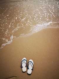 High angle view of shoes on beach