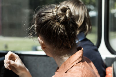 Rear view of man using mobile phone