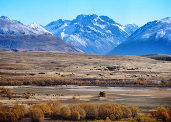 Scenic view of snowcapped mountains against blue sky