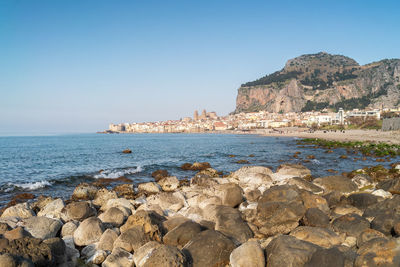 Idyllic view of cefalu cathedral and rocca di cefalu rocky mountain in cefalu, sicily.