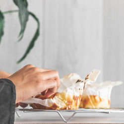 Close-up of hand holding ice cream in plate