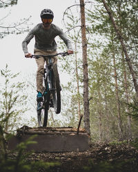 Low angle view of young man riding bicycle