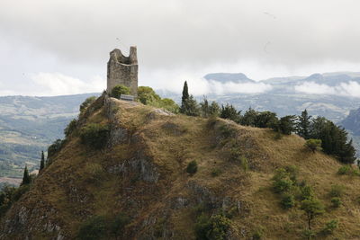 Castle on mountain against sky