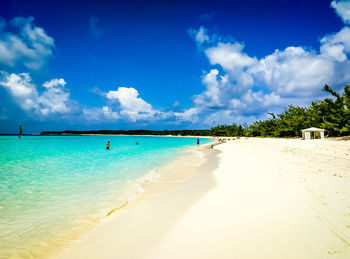 Scenic view of beach against blue sky