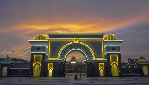 Illuminated malaysia national palace against sky during sunset