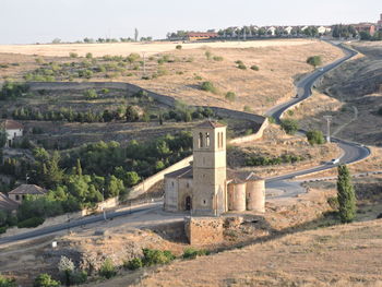 Built structure on landscape against the sky