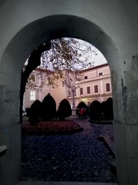 People on building seen through arch