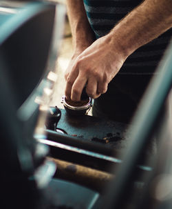 Midsection of man preparing coffee