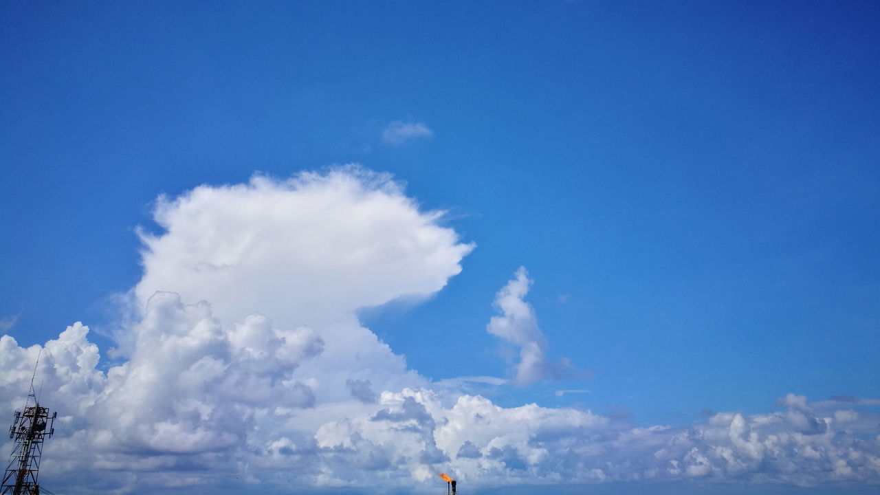 LOW ANGLE VIEW OF BLUE SKY AND BUILDINGS AGAINST CLOUDS