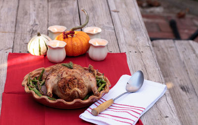 High angle view of roast chicken in container on table