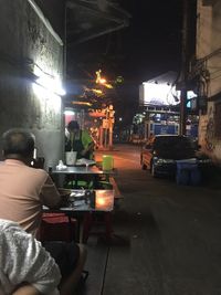 Rear view of people working at night